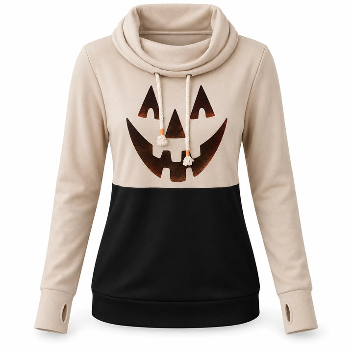 Pumpkin top in beige and black shown from the front on a white background with long sleeves, drawstrings and graphic visible.