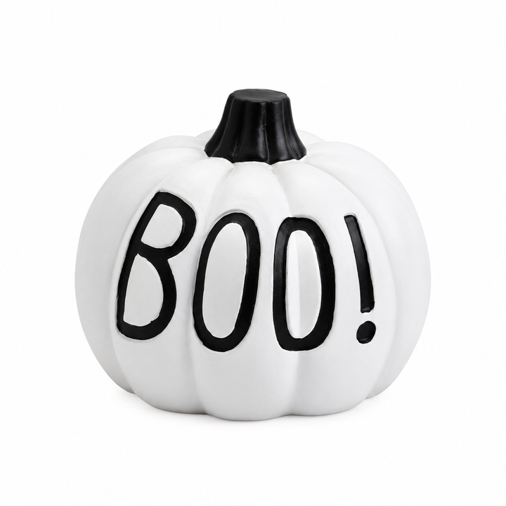 White Halloween pumpkin with black BOO! lettering, molded vertical grooves and a short black stem on a white studio backdrop.