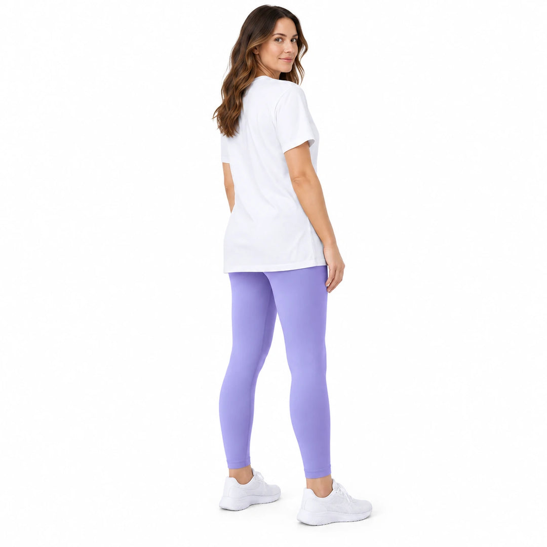 Adult model in Light Purple high-waisted leggings, white longline T-shirt and white sneakers on a pure white studio backdrop.