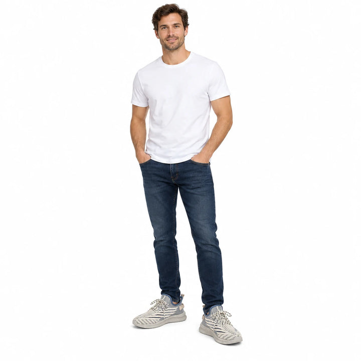 Adult male model wearing Beige mesh sneakers with dark jeans and a plain white T-shirt, fully visible on a plain white scene.