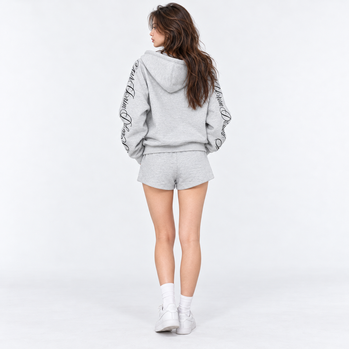 Gray zip hoodie and drawstring shorts modeled from the back