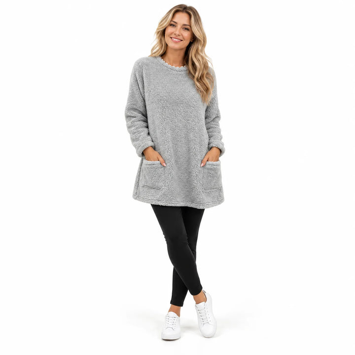 Light Gray long fleece pullover worn by an adult woman, with a round neck and front patch pockets, in a white studio setting.