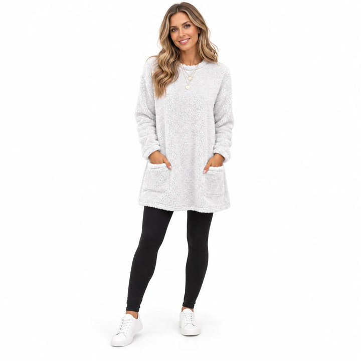 White long fleece pullover worn by an adult woman, showing the round neckline and fleece texture, against a white background.