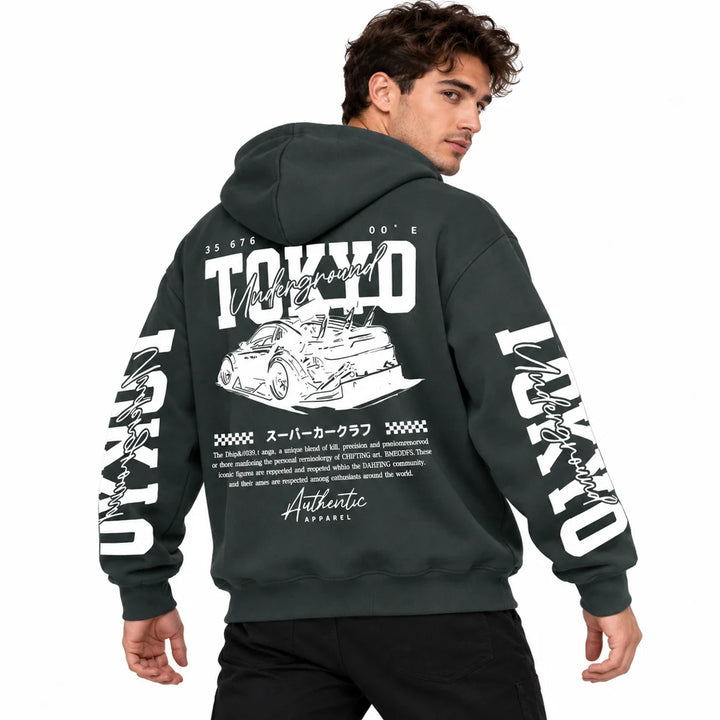 Male model wearing Charcoal Tokyo racing graphic hoodie, showing back artwork and sleeve prints