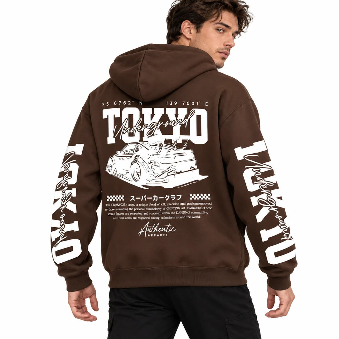 Male model wearing Chocolate Brown Tokyo racing graphic hoodie, showing back artwork and sleeve prints