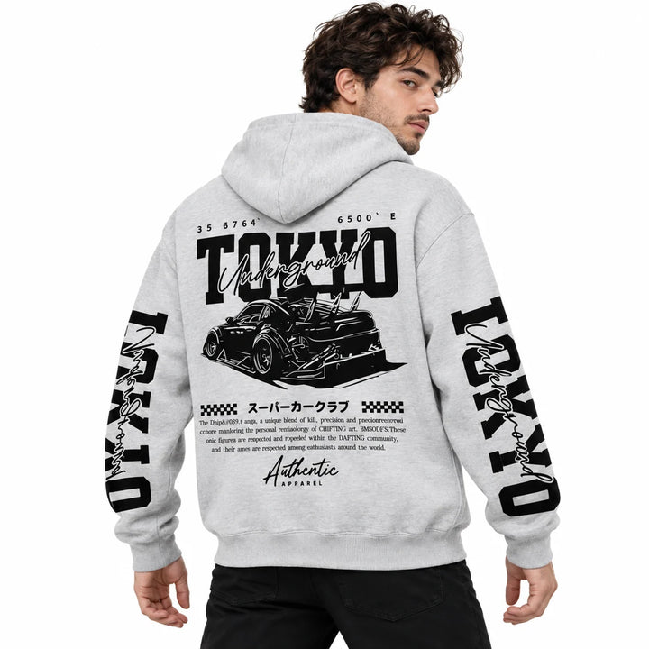 Male model wearing Light Heather Grey Tokyo racing graphic hoodie, showing back artwork and sleeve prints