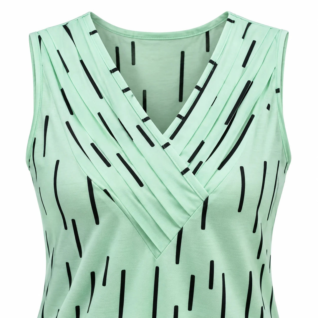 Mint Green neckline detail with overlapping pleats, broad shoulder straps and black geometric dash print on white background.