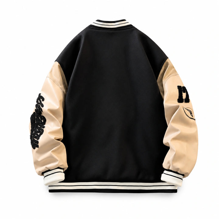 Black varsity jacket back view with a plain panel, cream contrast sleeves, sleeve patches and striped ribbed trim.