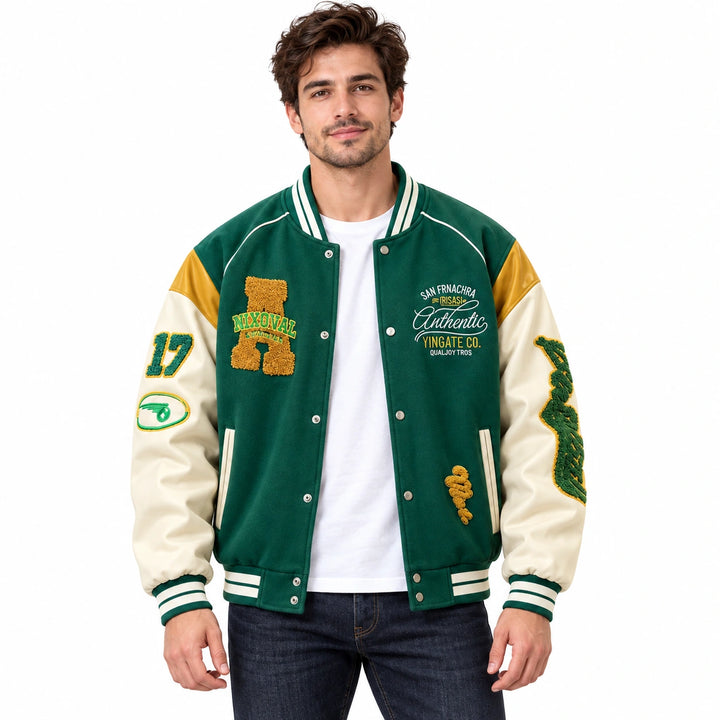 Male model wearing the Green varsity jacket with cream sleeves and yellow shoulders over a white T-shirt and jeans.