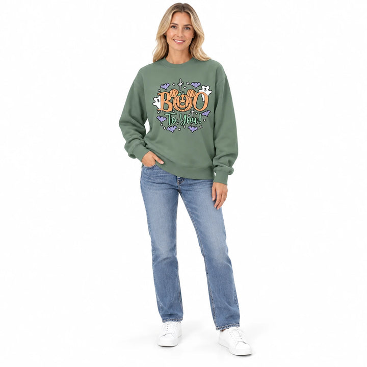 Olive green crewneck sweatshirt with a Boo To You print on an adult model wearing jeans and white sneakers in a white studio.