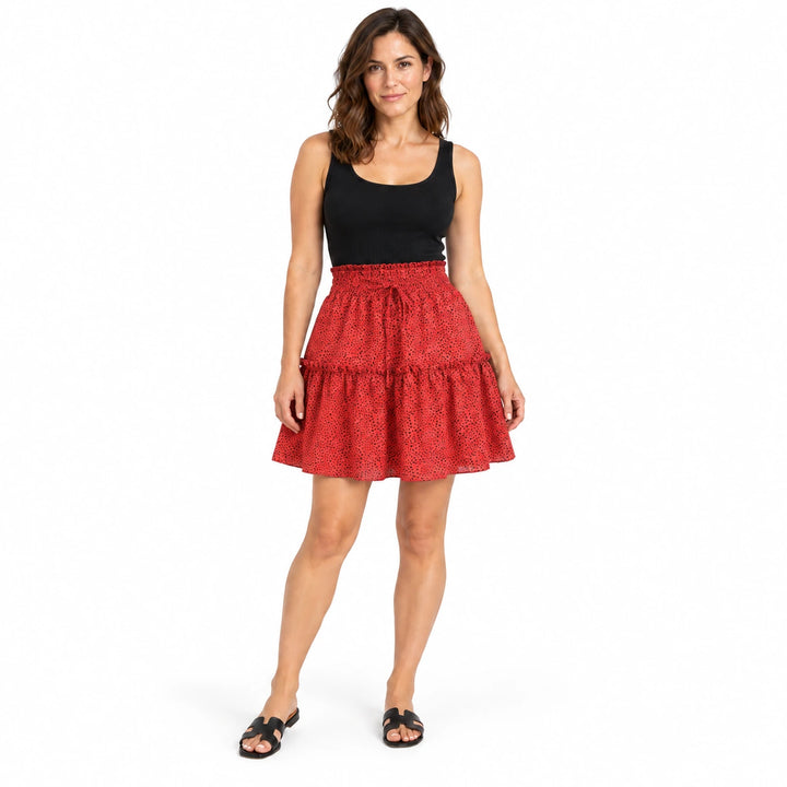 Model wearing the red polka dot chiffon skirt with a black top and sandals