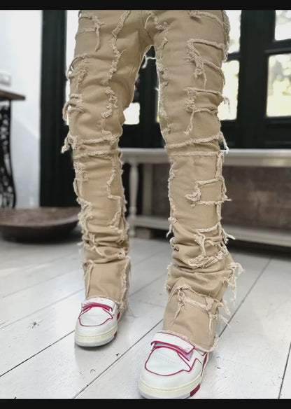 men's stacked jeans close-up of fringe rip and patch stitching on cotton denim for premium streetwear finish
