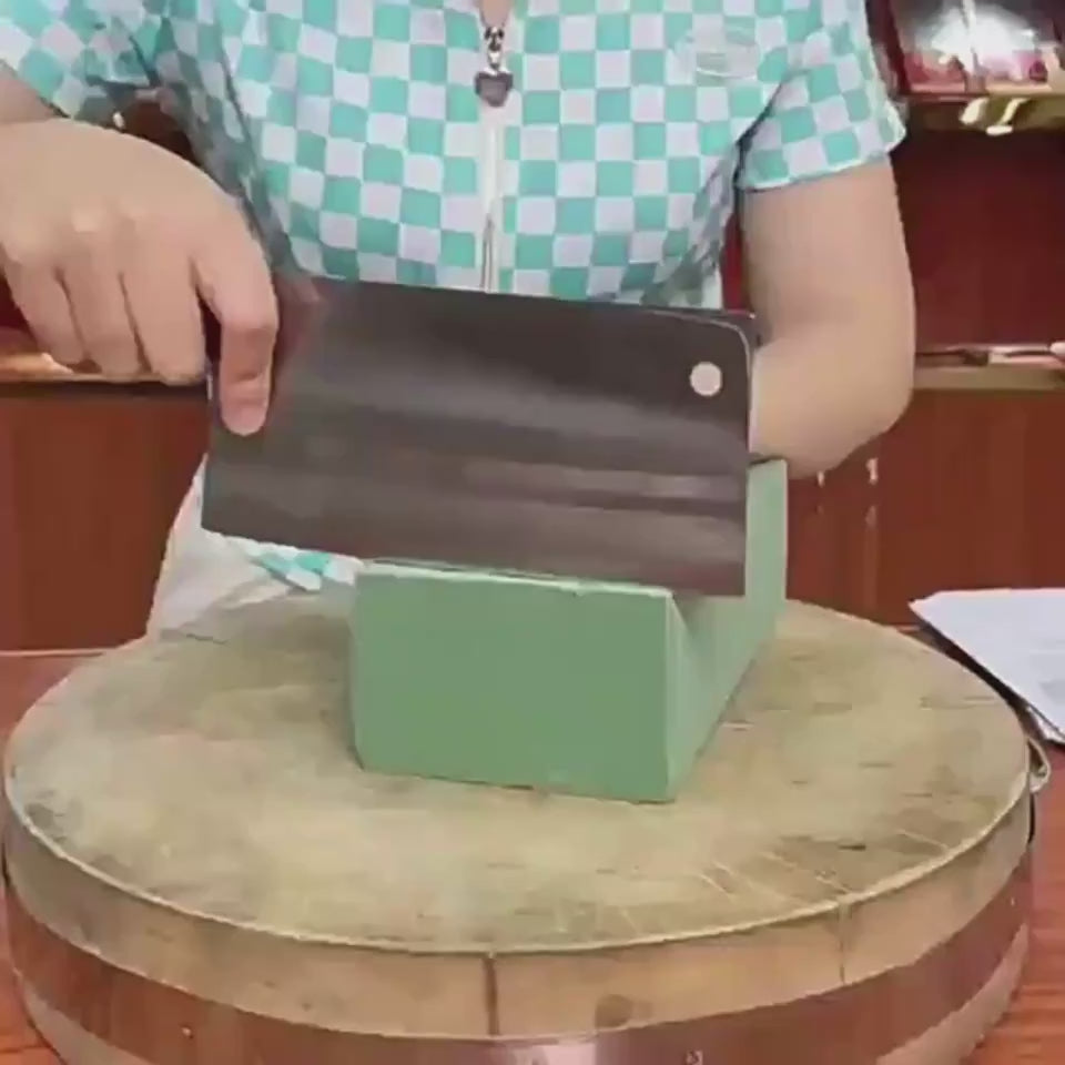 household kitchen knife stainless steel used for vegetable prep on neutral stone surface