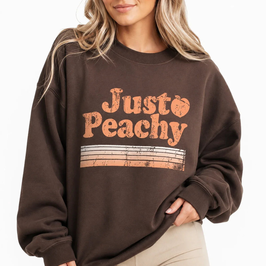 Close-up of Coffee Brown printed sweatshirt for women showing the crew neck, texture and Just Peachy print.