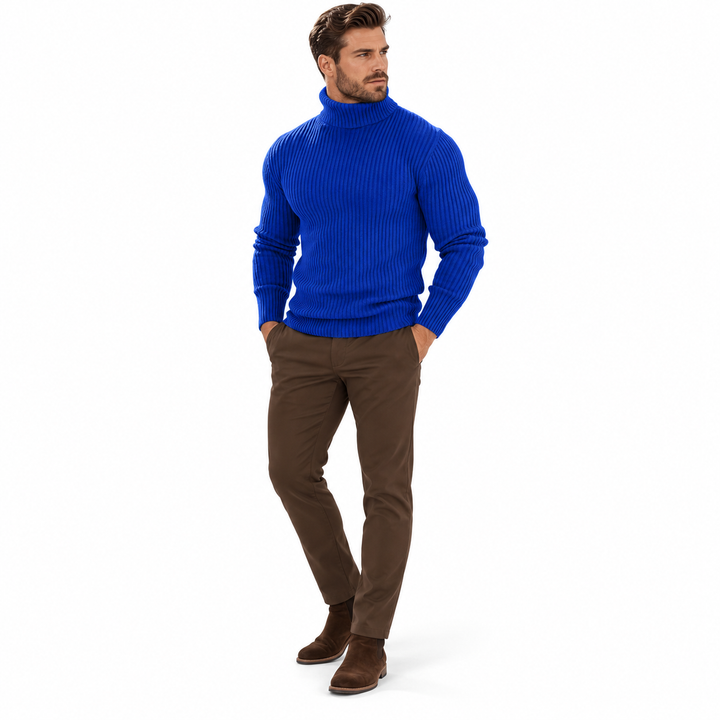 Three-quarter front view of sapphire blue ribbed turtleneck with brown trousers.