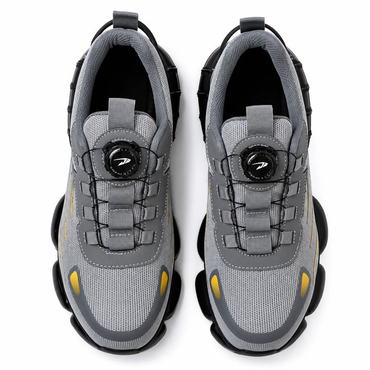 Top view of grey athletic steel toe shoes with dial-style fastening on a white background.