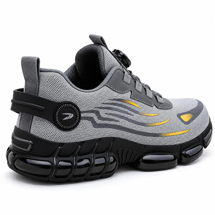 Rear three-quarter view of a grey mesh steel toe shoe with heel pull tab and black outsole.