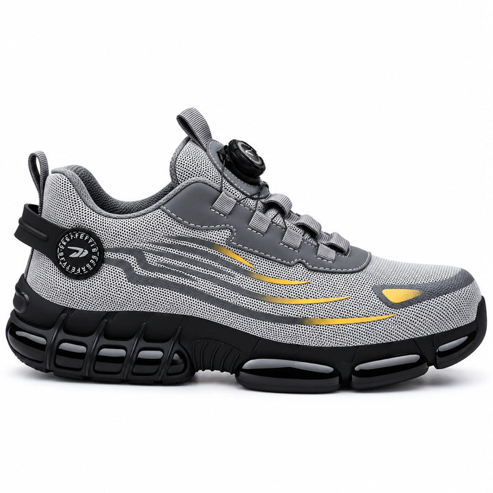 Side profile of a grey athletic steel toe shoe with yellow accents and a black segmented outsole.