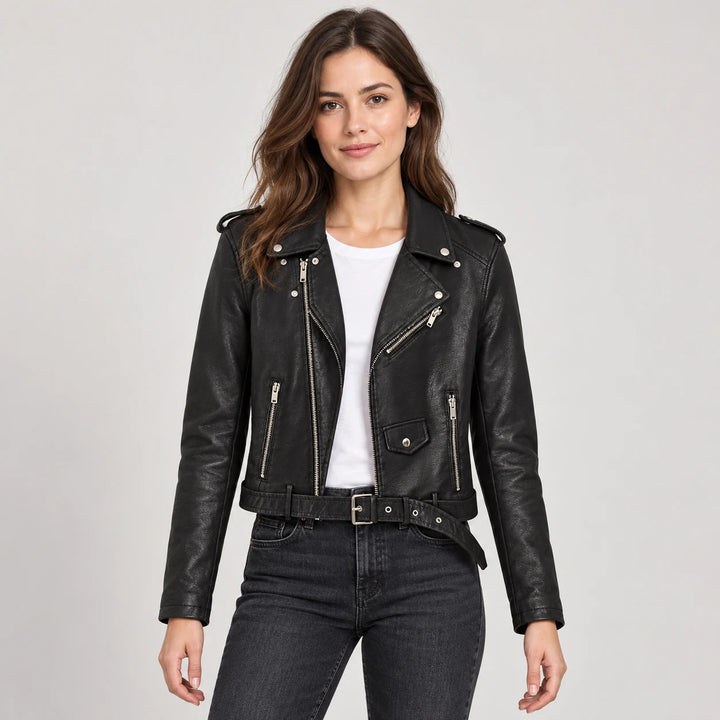 Model wearing a black biker jacket with belt, worn over a white top and dark jeans, with the lapels and long sleeves visible.