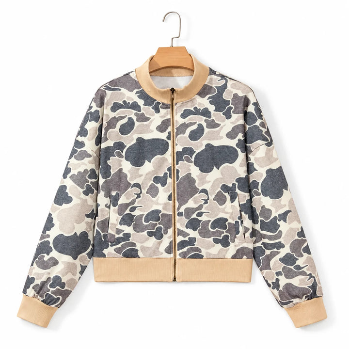 Camouflage sweatshirt on a wooden hanger against a white backdrop, showing the full zip front, pockets and beige ribbed trim.