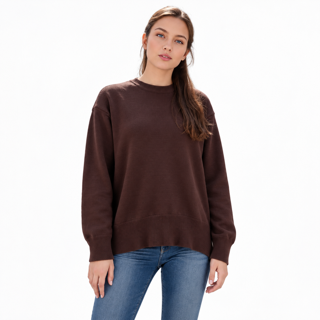 Coffee knitted pullover on a model in a white studio, with a crew neckline, dropped shoulders, long sleeves and ribbed edges.