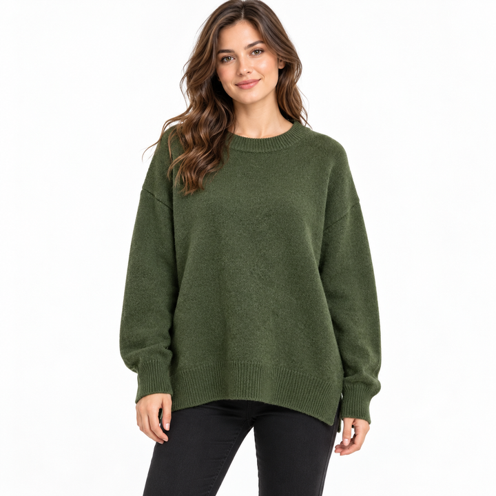 Dark Green knitted pullover on a model against white, with a crew neckline, dropped shoulders, long sleeves and ribbed edges.