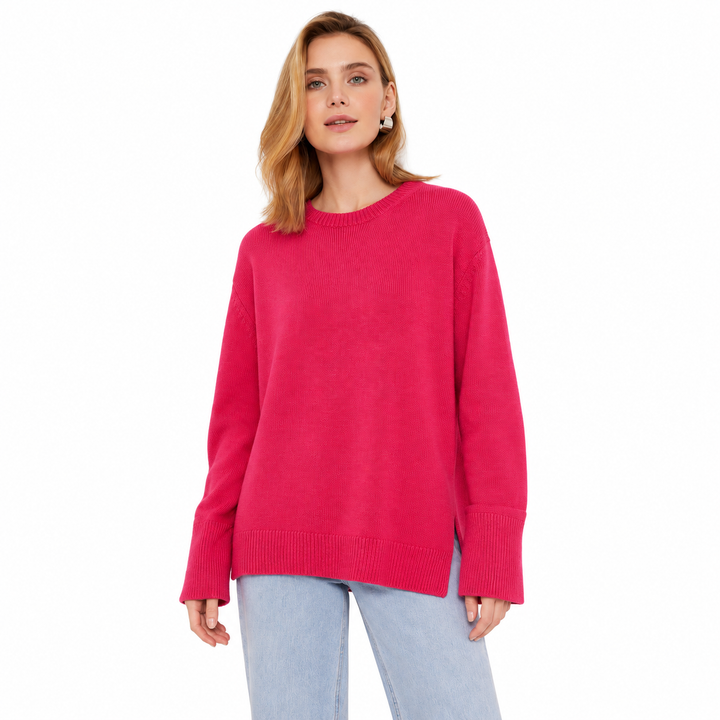 Rose red knitted pullover on a model against white, showing its bright shade, a round neckline, relaxed fit and ribbed cuffs.