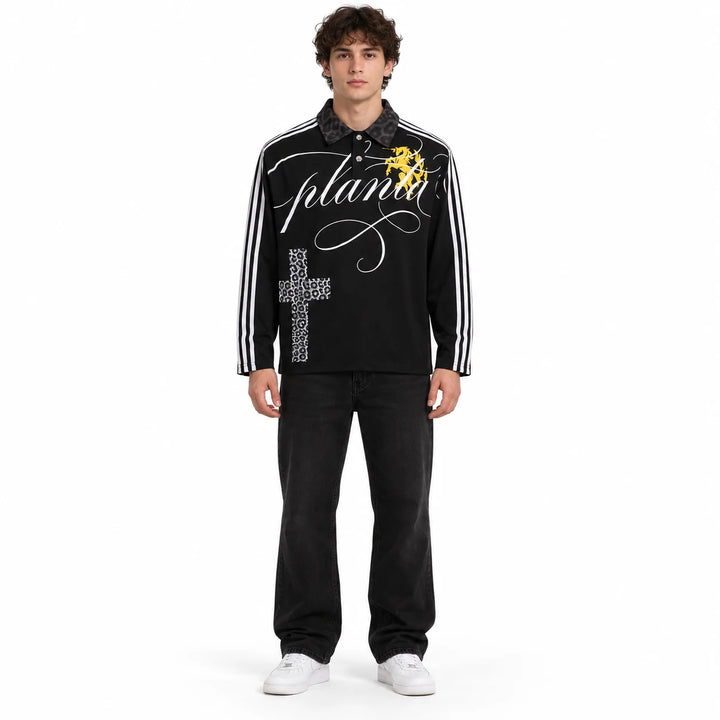 Adult male model wearing a Black long sleeve polo shirt with white sleeve stripes, printed cross and a dark patterned collar.