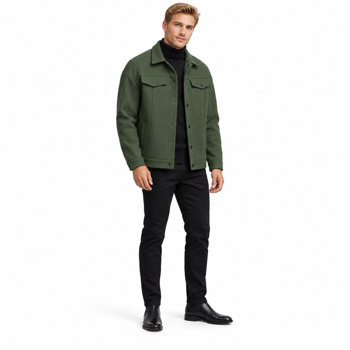 Army green jacket on a full-body blonde adult male model, with a pointed collar, flap chest pockets and black snaps on white.