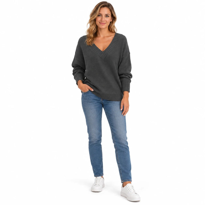 Adult woman wearing the Dark Gray V-neck knit pullover, in a full-length studio pose against a plain white studio background.