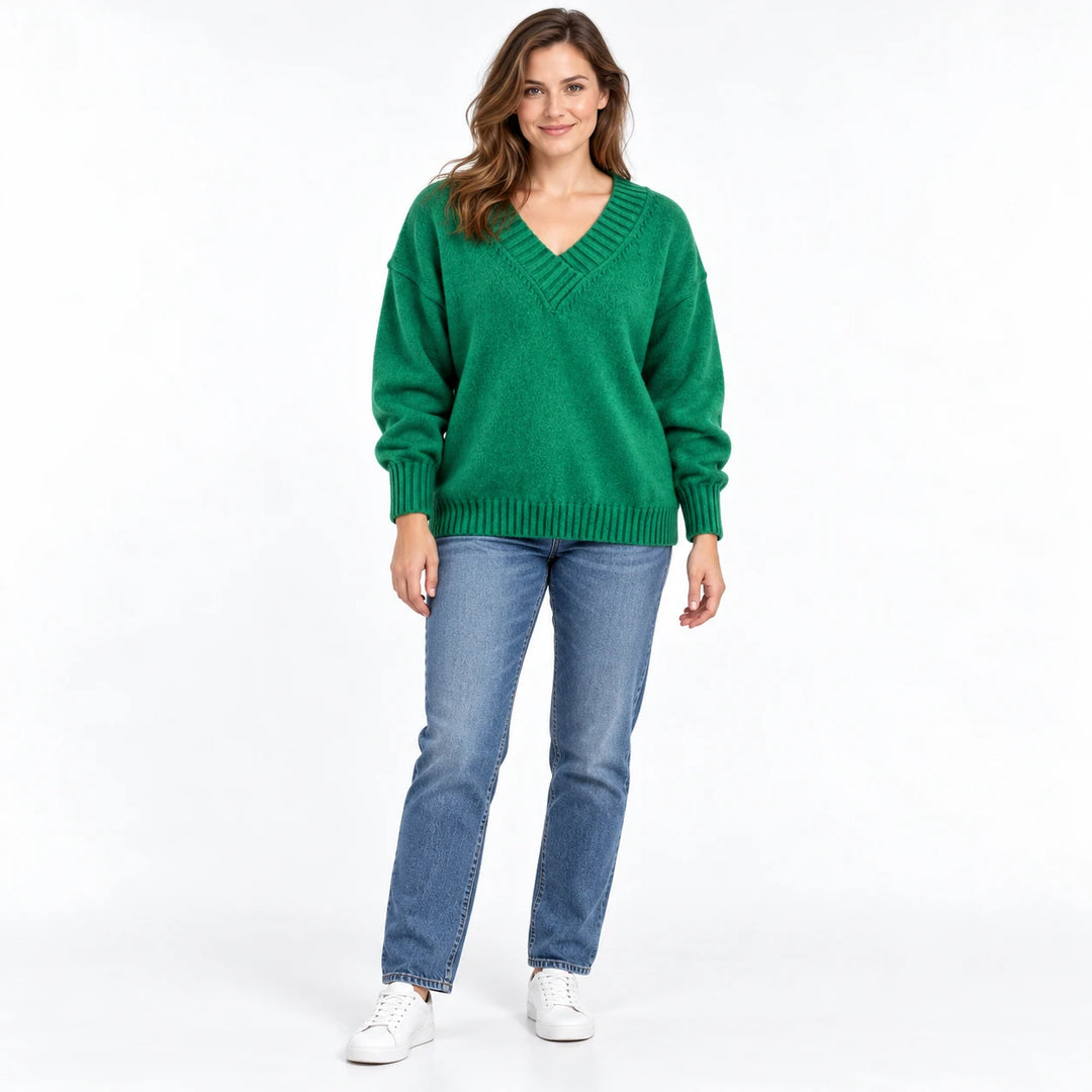 Adult woman shown wearing the Green V-neck knit pullover, in a full-body studio view against a plain white studio background.