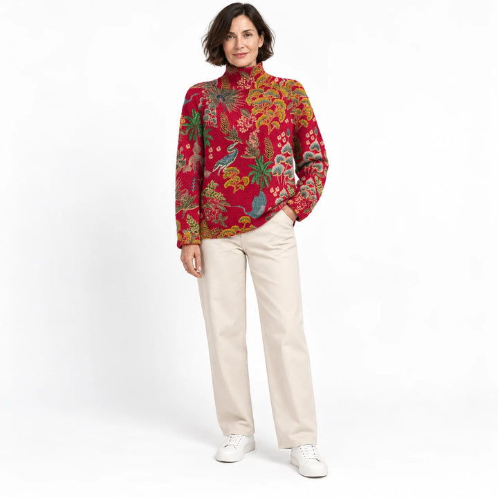 Short-haired adult woman shown wearing the high-neck pullover in the Bright Red floral design, in a front view against white.