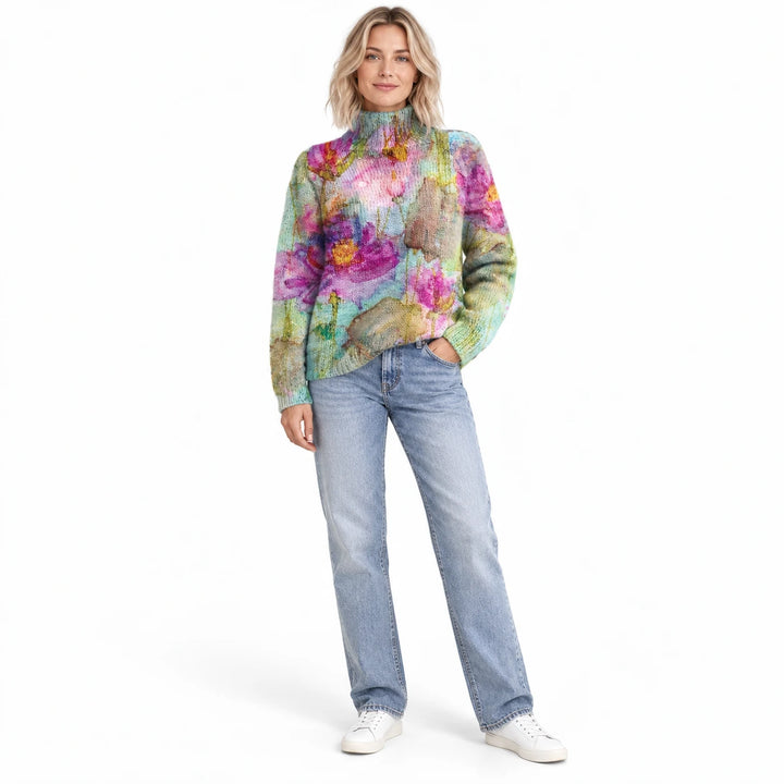 Adult woman wearing the printed high-neck pullover in the Indigo design, in a full-body studio view against a white backdrop.