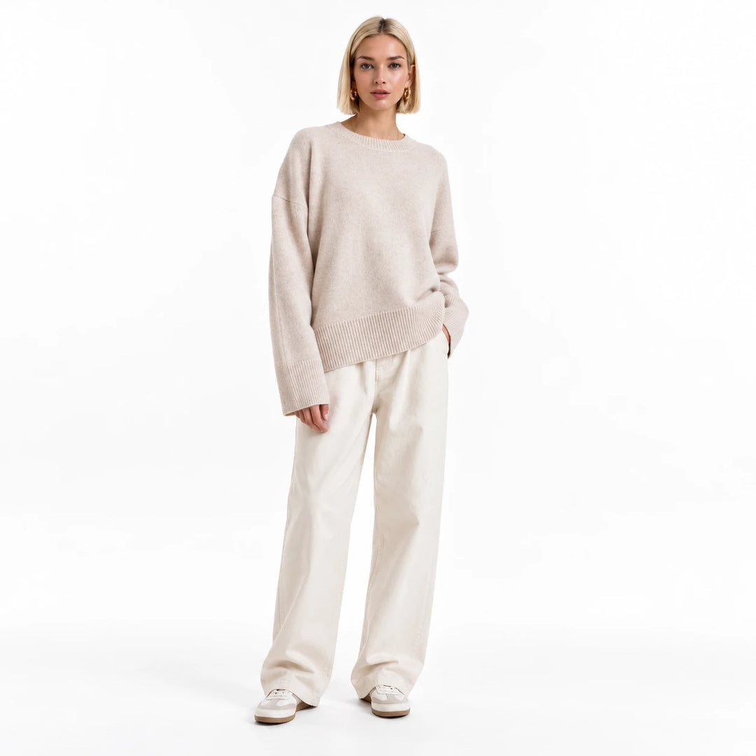 Adult woman modelling the Apricot round-neck draped pullover, in a front studio pose against a plain white studio background.