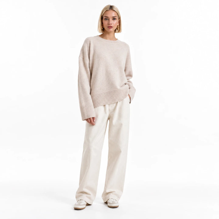 Adult woman modelling the Apricot round-neck draped pullover, in a front studio pose against a plain white studio background.