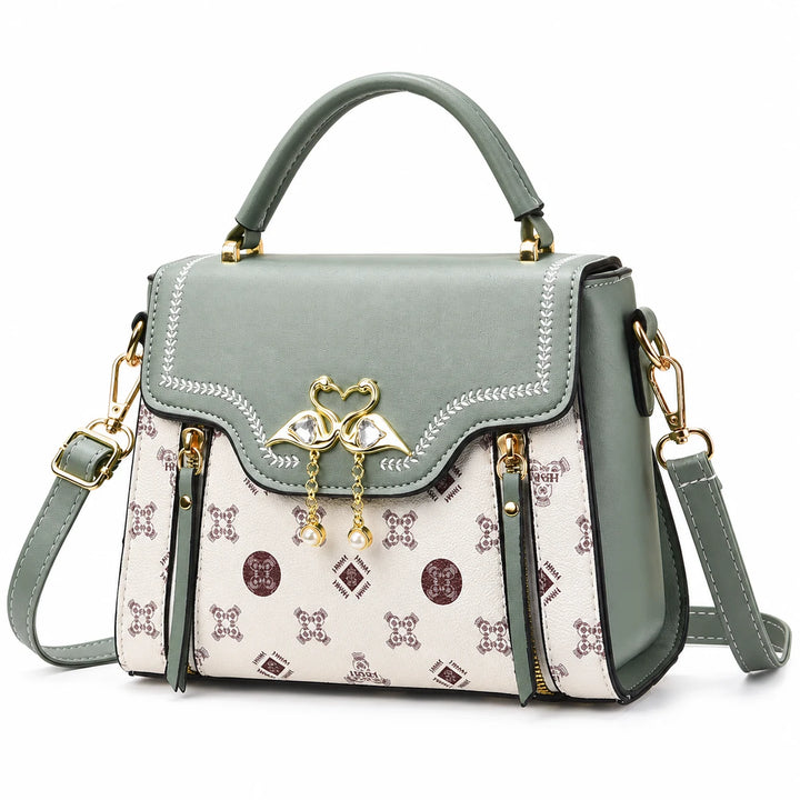 Green square crossbody bag with patterned front and flap closure on a white background.