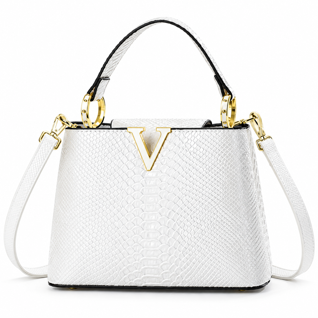 White crossbody bag in front product view showing the embossed scale pattern, top handle, shoulder strap and gold V ornament.