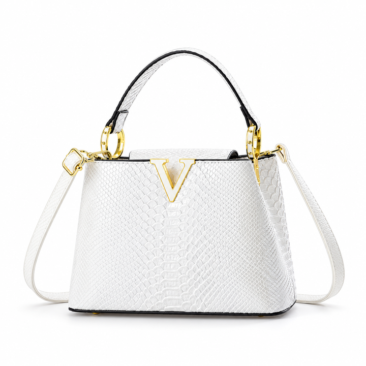 White PU handbag in wider front product view showing its top handle, embossed surface and gold-tone ornament on white ground.