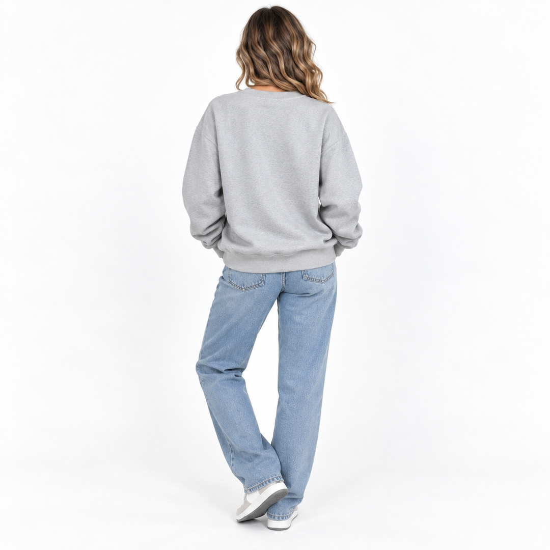 Back view of relaxed unisex sweatshirt showing the garment shape, long sleeves and ribbed hem in a clean studio setting view.