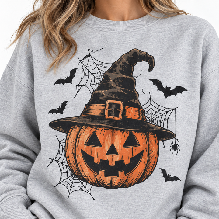 Detail view of Halloween graphic with pumpkin, witch hat, bats and spider web elements on the sweatshirt front design detail.