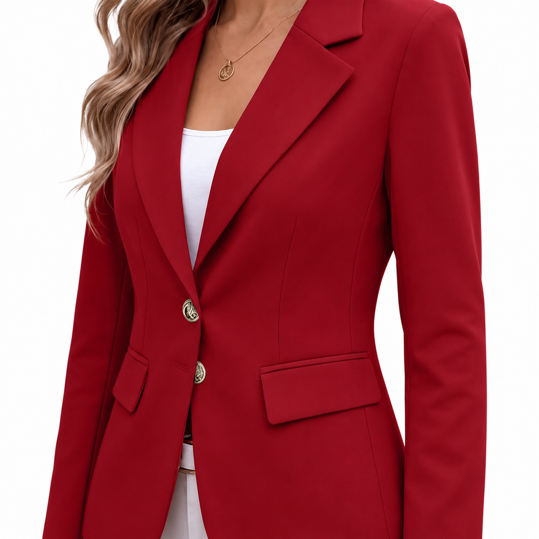 Red blazer close-up showing notch lapel, two-button front, flap pocket and tailored seam details on a clean white background.