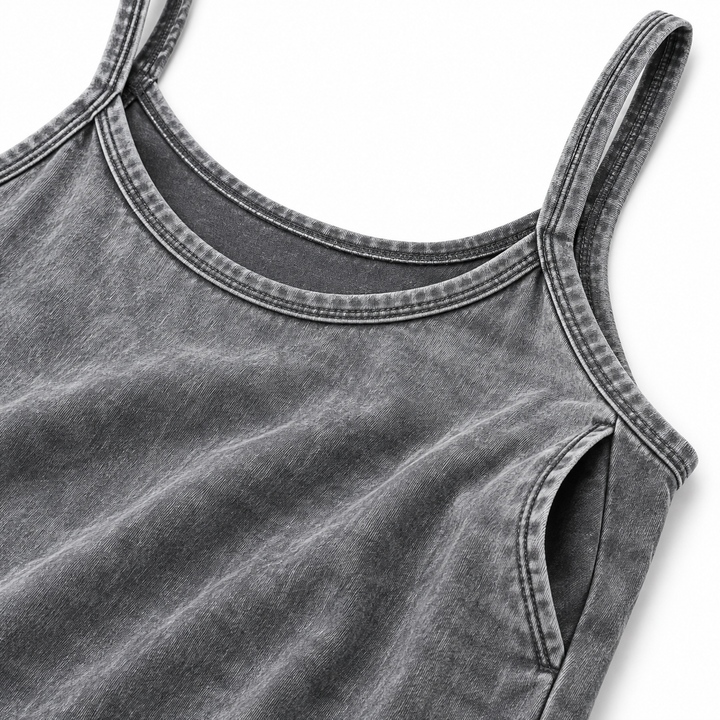 Close-up of gray washed dress fabric, neckline stitching, thin straps and side pocket construction