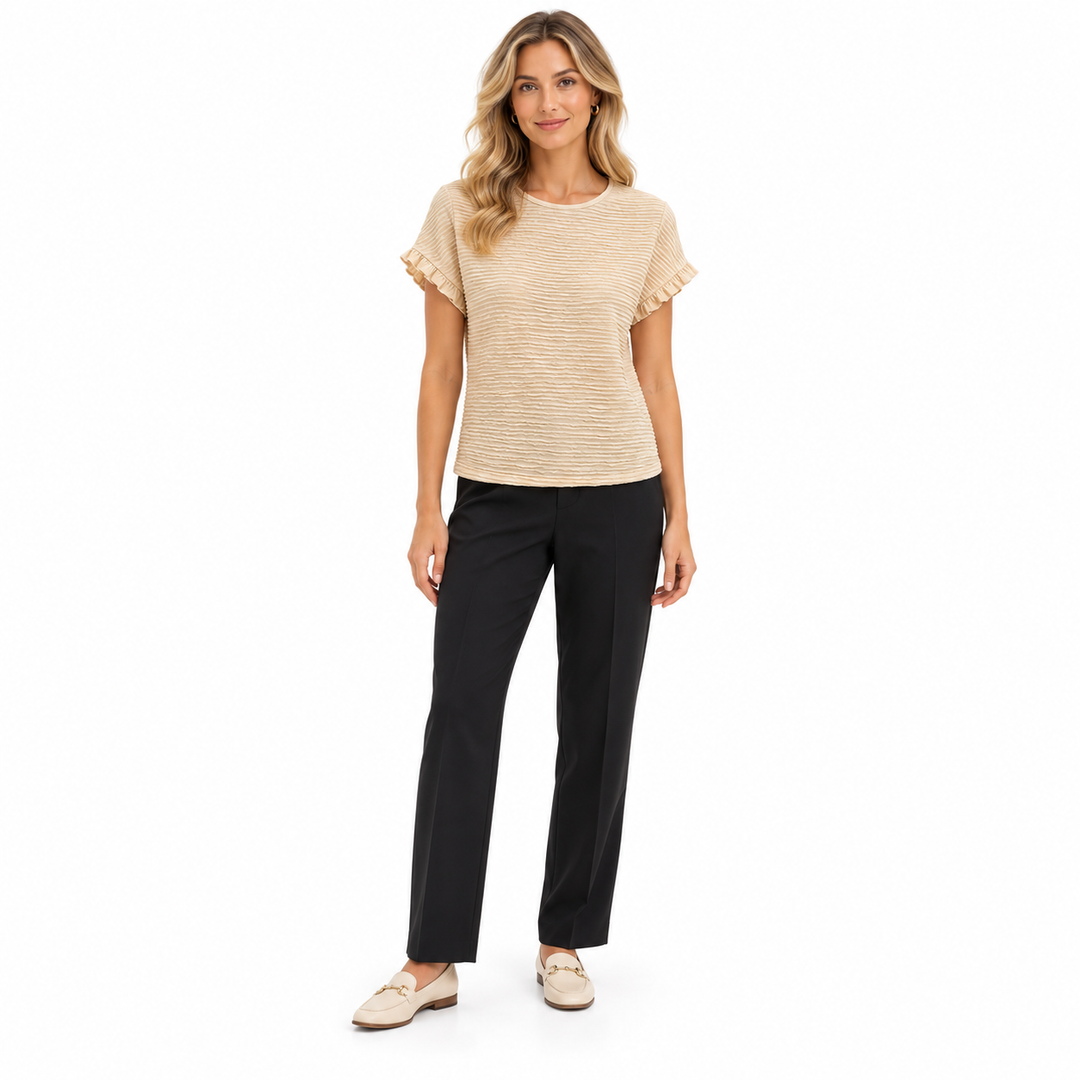 Apricot ruffle sleeve blouse on a full-length model with dark tailored trousers, showing a round neckline and textured finish