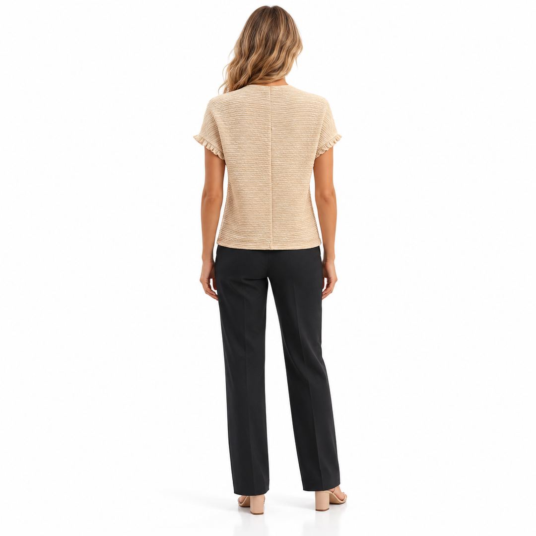 Back view of the Apricot top on a full-length model, showing a center seam, textured surface, straight hem and sleeve ruffles