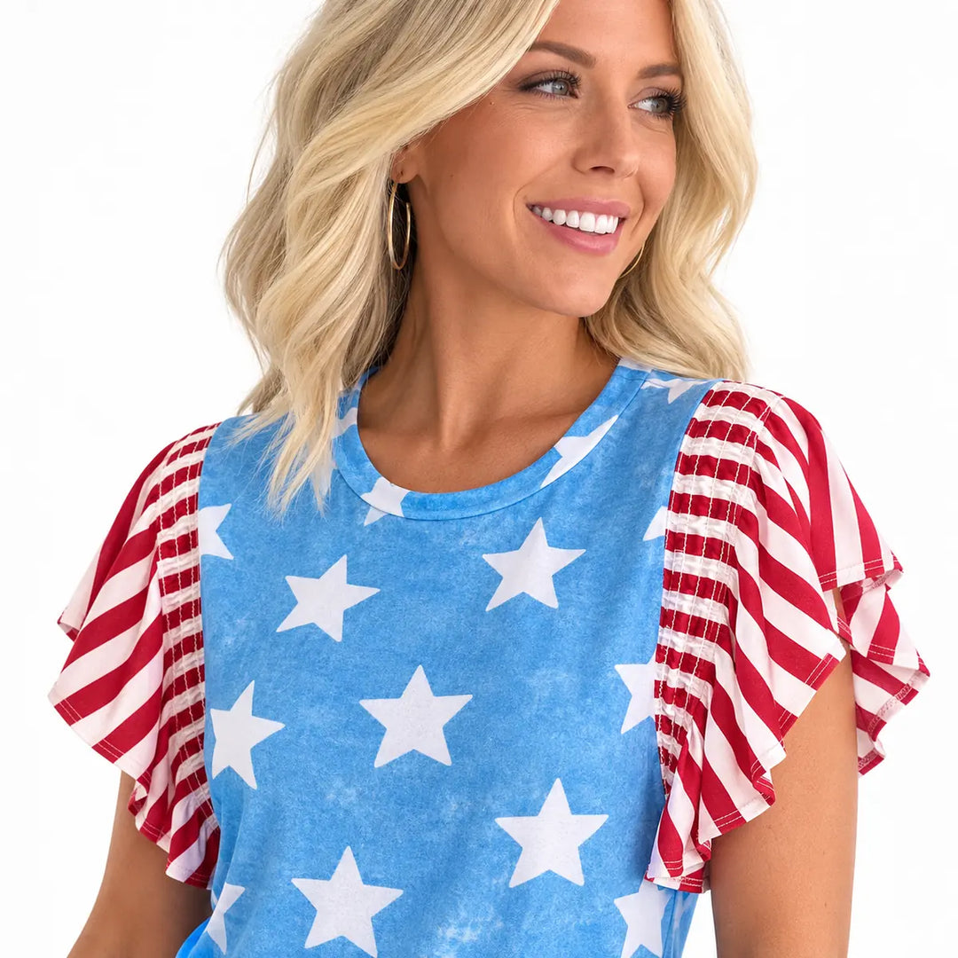Detailed view of the round neckline and gathered shoulder panel joining the star body print to the striped short sleeve seam.