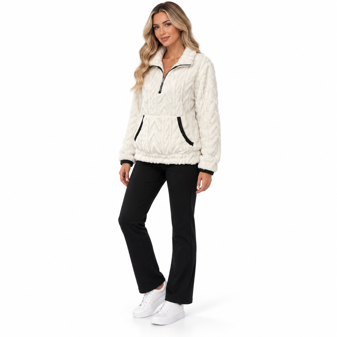 Three-quarter view of the white textured pullover on a blonde woman, showing the collar, front pocket and relaxed silhouette.