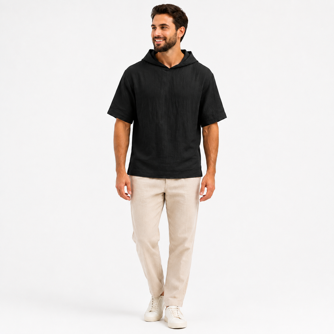 Man wearing a black short sleeve pullover hoodie, full-body front view on a clean white background.