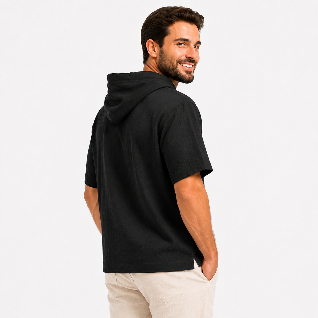 Rear close view of a black short sleeve hoodie showing the hood, shoulder line, sleeve, and hem.