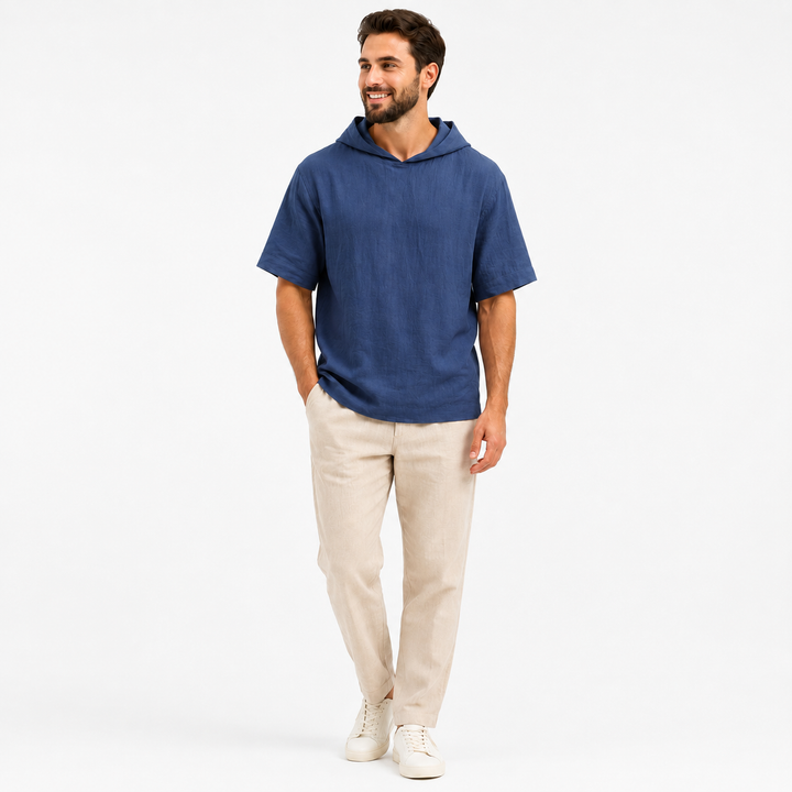 Man wearing a sapphire blue short sleeve pullover hoodie, full-body front view on a white background.