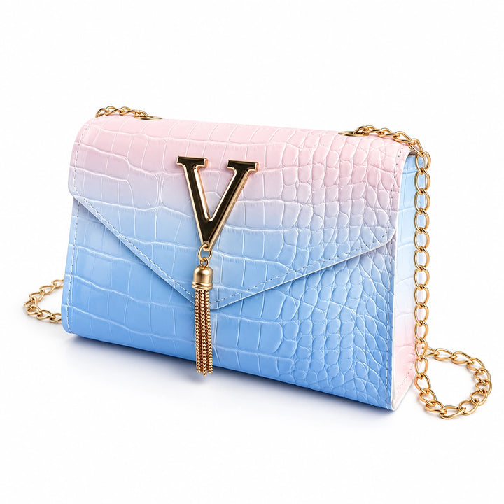Blue gradient chain shoulder bag with embossed texture, gold V detail and tassel on white